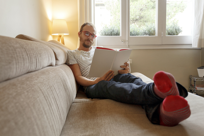 man relaxing on sofa reading book 2022 03 04 01 47 18 utc 2